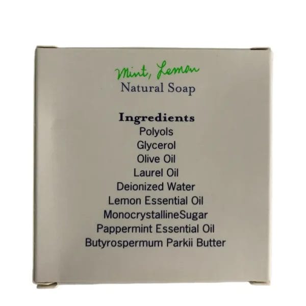 A macro close-up of the Hotel Soaps Lemon DETOX Natural Soap, revealing the rich shea butter lather and gentle monocrystalline sugar exfoliants.