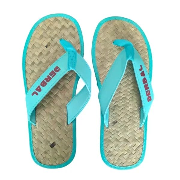 A macro close-up of the textured, high-friction rubber outsole on the bottom of the Raffia Straw Flip Flops.