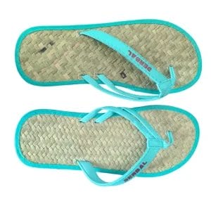 Natural Raffia Straw Flip Flops placed neatly on a bamboo mat inside a serene, high-end hotel wellness spa.