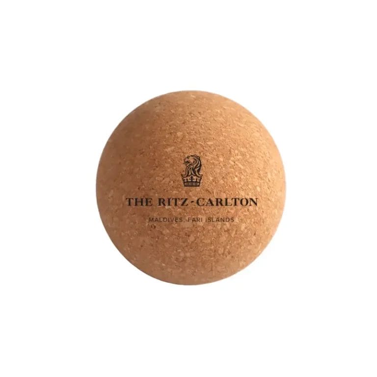 A complete hotel wellness set featuring a **cork-yoga-ball**, rubber mat, and natural spa accessories.