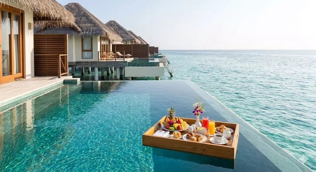 Maldives luxury resort hotel supplies pool floating tray breakfast champagne tropical overwater villa