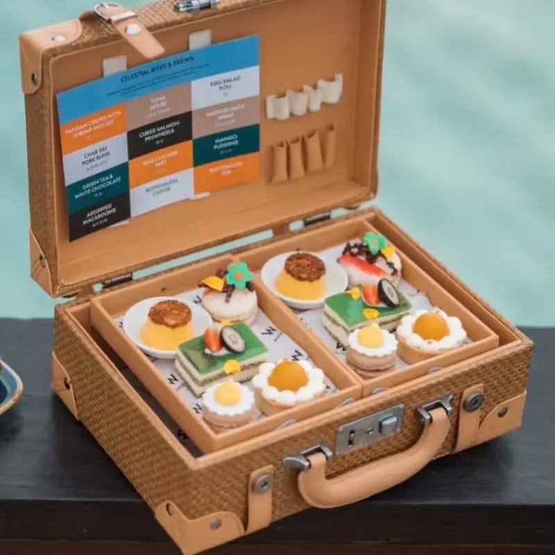 Luxury beachfront picnic setup in the Maldives featuring a DERBAL wicker picnic basket.