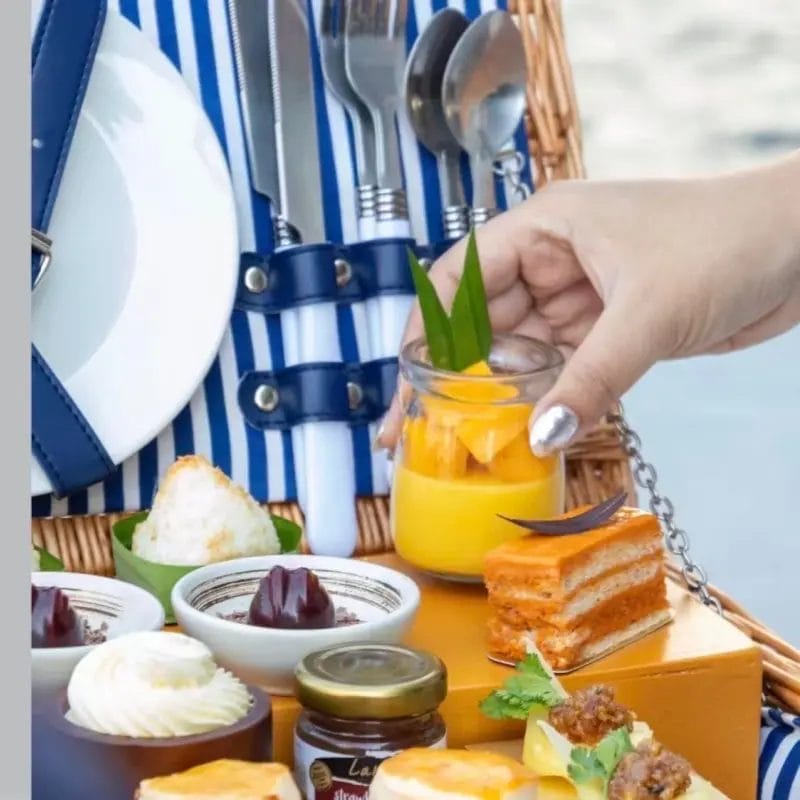 A wicker picnic basket presented as an in-room wellness or dining amenity in a luxury hotel suite.